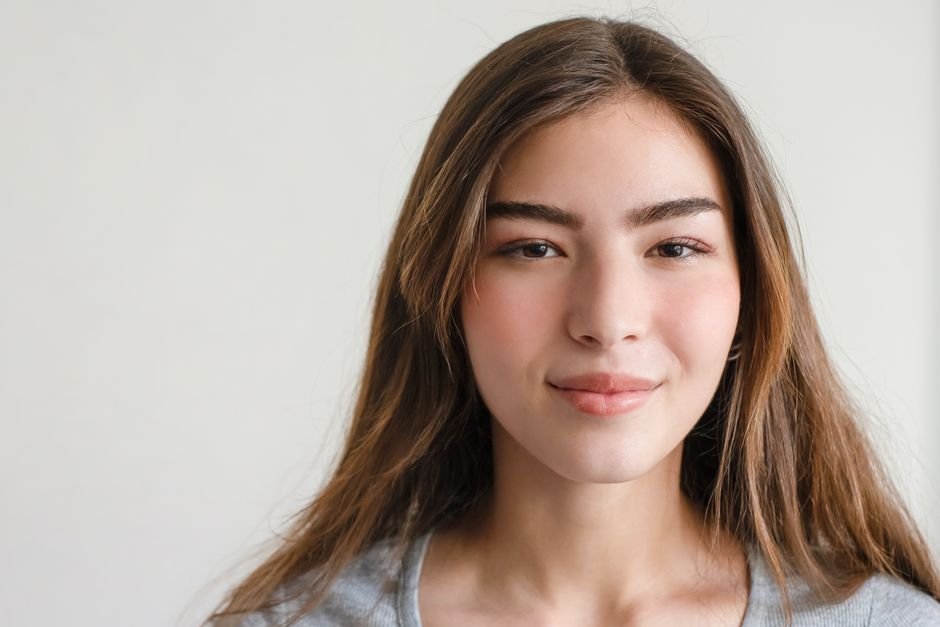 Close-up portrait of a woman with a confident, relaxed smile