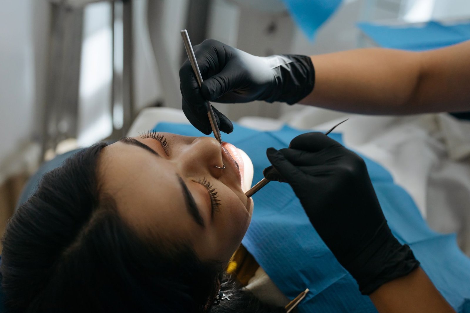 Dentist examining a patient's teeth with dental instruments during a checkup