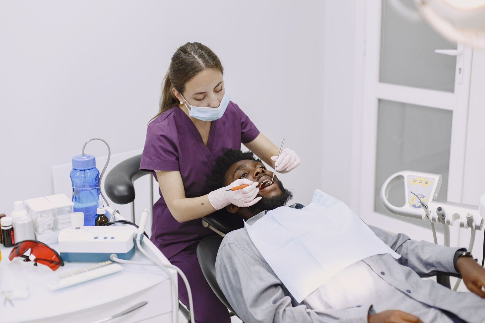 Dental hygienist cleaning a patient's teeth in a dental clinic